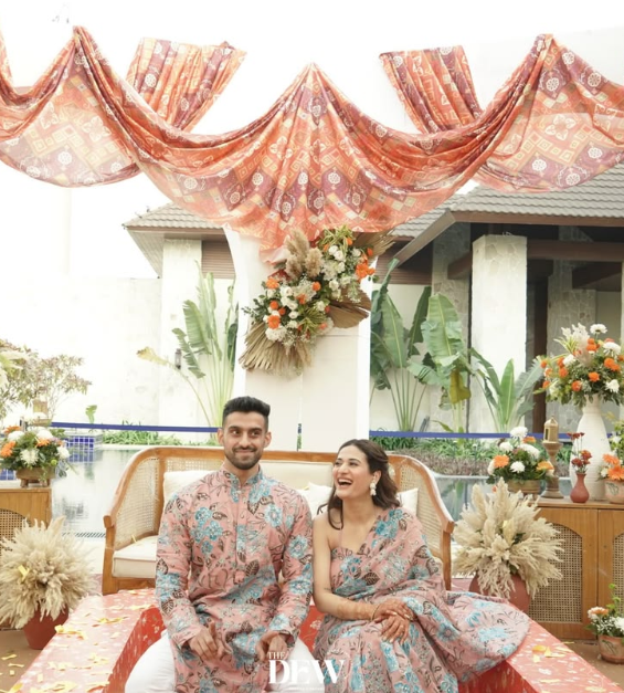 Traditional haldi celebration with yellow floral wedding décor